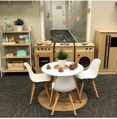 a table and chairs in a room with shelves