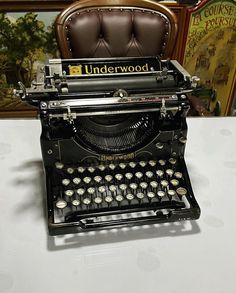 an old fashioned typewriter sitting on top of a table