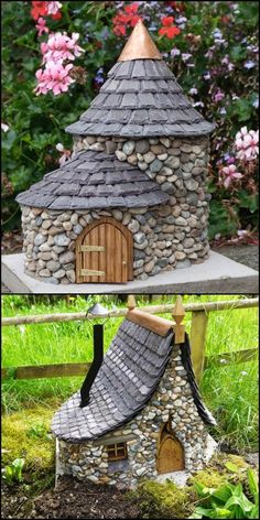 a small house made out of rocks and wood