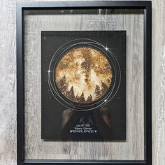 an image of a pie in a frame on the wall with stars and trees around it