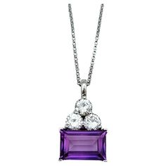 Indulge in the impeccable craftsmanship of this Oliver Smith pendant necklace, a testament to refined luxury and timeless elegance. Set in gleaming 18 karat white gold, the pendant features a mesmerizing emerald cut amethyst of exceptional clarity and depth, exuding a regal purple hue that captivates the eye. Sitting atop the amethyst are three brilliant round diamonds, carefully arranged to enhance its brilliance and create a striking contrast against the rich color of the gemstone. The pendant Luxury Purple Necklace With Large Pendant, Luxury Amethyst Round Pendant Necklace, Multicolor Amethyst Pendant Jewelry, Oliver Smith, Luxury Amethyst Pendant Necklace, Art Deco Pendant Necklace, Purple Multi-stone Pendant Gemstones, White Gold Pendant Necklace, Gold Snake Chain