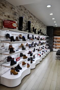 a row of shelves filled with lots of different types of shoes on top of each other