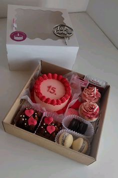 a box filled with lots of different types of cupcakes