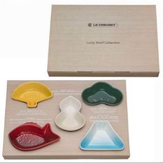 four different shaped dishes in a box