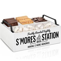 a white box filled with different types of marshmallows and s'mores