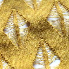 a piece of yellow fabric with lace on it