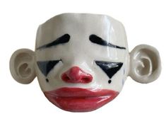 a close up of a clown mask on a white background