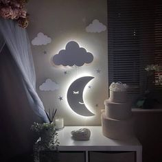 a white table topped with a cake next to a night sky and clouds wall mural