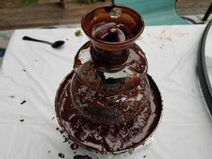 a brown vase sitting on top of a table covered in melted chocolate next to a mirror