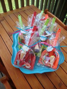 a blue plate topped with lots of food on top of a wooden table covered in plastic bags