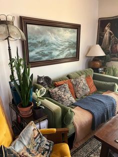 a living room filled with furniture and paintings