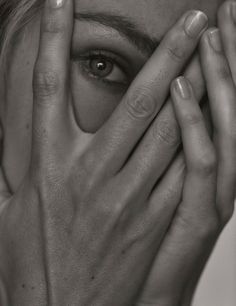 a woman covering her face with her hands