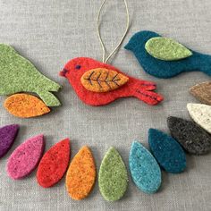 felt bird ornaments are arranged in a circle