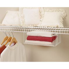 a white shelf filled with lots of pillows and blankets