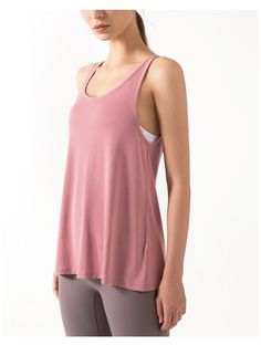 The EMES SHOP tank top is detailed with a scoop neckline. and thick tank straps that connect in an open triangle back. Features a twist detail mid-back. and flares out to an open split that can be tied and falls below the hips. This light-weight. super breathable tank is perfect for laying over sports bras for a run. workout. hike. yoga. or even simply every day wear.MATERIAL: 70% Modal. 30% PolyesterMEASUREMENTS: Small | Bust: 41" cm . Length: 60" cm Medium | Bust: 43" cm . Length: 62" cm Large | Bust: 45" cm . Length: 64" cm XL | Bust: 47" cm . Length: 66" cm MEASUREMENTS: Small | Bust: 16.14" in . Length: 23.6" in Medium | Bust: 16.9" in . Length: 24.4" in Large | Bust: 17.7" in . Length: 25.2" in XL | Bust: 18.5" in . Length: 26" in Casual Cross Back Tank Top With Built-in Bra, Yoga Top With Built-in Bra And Scoop Back, Stretch Tank Top With Cutout Back For Summer, Seamless Cross Back Tank Top For Summer, Summer Seamless Cross Back Tank Top, Sleeveless Workout Tops With Adjustable Straps, Scoop Neck Tank Top For Spring Yoga, Summer Camisole With Built-in Bra And Scoop Back, Summer Yoga Camisole With Scoop Neck