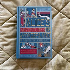 the book alice's adventures in wonderland is laying on a bed with white sheets