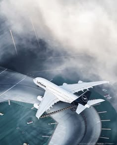 an airplane is flying over the ocean on a cloudy day in this aerial photo taken from above