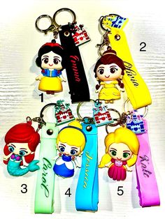 several key chains with cartoon characters attached to them, all in different colors and sizes