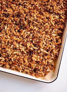 a casserole dish filled with granola on top of a white countertop