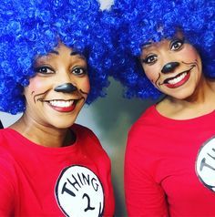 two women wearing blue wigs and cat in the hat shirts