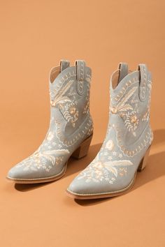 Delicate florals dance across these boots, adding a touch of unique personality and charm. The classic pointed toe and stacked heel nod to the timeless style of the Wild West. Fancy Western Party Decor, Fall Floral Embroidered Snip Toe Boots, Fall Floral Embroidery Snip Toe Boots, Bohemian Boots With Floral Embroidery For Fall, Bohemian Fall Boots With Floral Embroidery, Bohemian Floral Embroidered Boots For Fall, Embroidered Pointed Toe Boots For Fall, Bohemian Snip Toe Boots For Spring, Bohemian Snip Toe Spring Boots