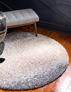 a living room with a chair and rug on the floor