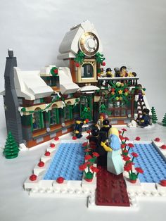 a lego christmas scene with people in front of a house