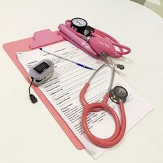 a pink clipboard with a stethoscope on top of it