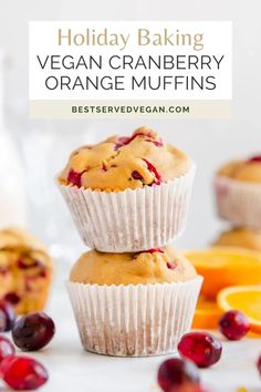 two orange muffins stacked on top of each other with cranberry topping