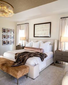 a bedroom with a large bed and pictures on the wall