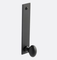 a black door handle on a white wall