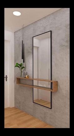 an empty room with a mirror, shelf and plant on the wall next to it