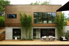 a modern house with an outdoor dining area