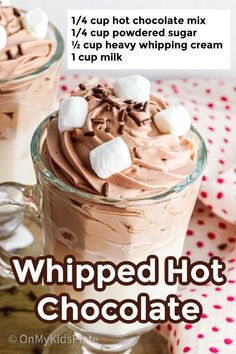 whipped hot chocolate in a glass mug with marshmallows on top