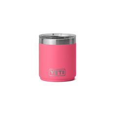 a pink yeti cup sitting on top of a white surface with the word yeti written