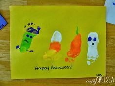 a child's handprinted halloween card with three different colored pumpkins on it