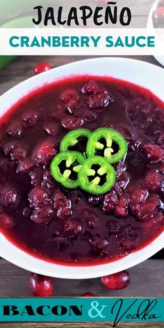 a white bowl filled with cranberry sauce and two jalapenos on top