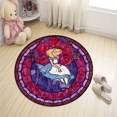 a stained glass door mat with a cartoon character on it and a teddy bear sitting next to it