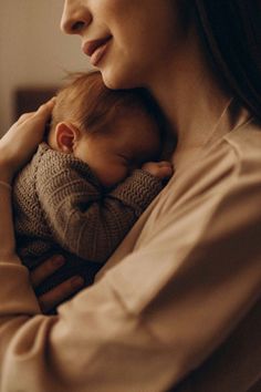 a woman holding a baby in her arms