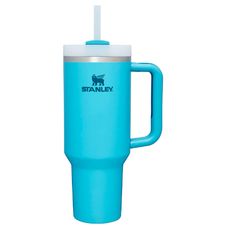 a blue travel mug with a straw in the cup is shown on a white background