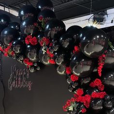 black balloons with red roses and happy birthday written on them