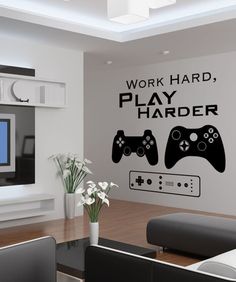 a living room with a large wall decal that says work hard play harder