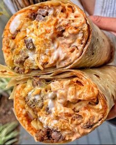 two burritos with meat and cheese on them