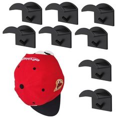 six baseball caps are lined up in front of each other, and one is attached to the wall