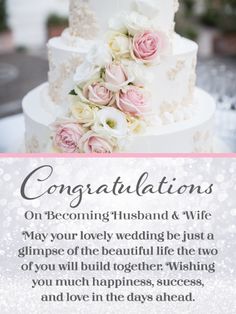 a wedding cake with flowers on top and congratulations card for the bride's husband