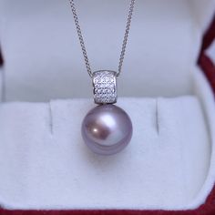 Dazzle in this stunning 11-12mm Freshwater Pearl Pendant Necklace. Handcrafted with 11-12mm freshwater pearls and blue gems, this necklace will be the perfect addition to any bridal ensemble. Boasting a remarkable luster and gleam, these pearls create a luxurious statement that will captivate the eye of any admirer. The deep purple hues of the pearls are perfectly complemented by sparkling blue gems for a truly timeless look. Elevate your style with this showstopper from House of Pearls. 11-12mm Wedding Pearl Necklace With Gemstone, Formal Bridal Necklace With Pearl Pendant, Adjustable Pearl Necklace, Formal Pearl Necklace With Gemstone, Silver Bridal Necklace With Pearl Charm, Baroque Pearls Necklace, Mother Of Pearl Earrings, Baroque Pearl Earrings, Pearl Necklaces