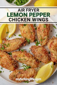 air fryer lemon pepper chicken wings on a white plate with lemons and parsley