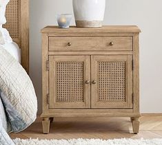 a wooden cabinet with two baskets on top of it