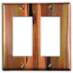 two light switch plates are shown in copper and black marbled metal, one is white