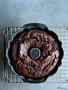 a chocolate cake sitting on top of a cooling rack